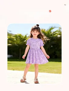Detailed close-up of light purple cotton girl dress with black heart pattern and ruffles