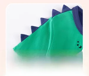 Detail of baby cotton t-shirt featuring purple dinosaur back spine accents on shoulder