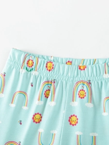 Little girl's light blue cotton pants with elastic waistband and rainbow cloud prints