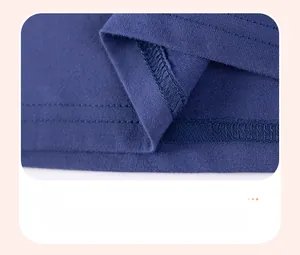 Detail of the double-needle stitching and smooth hemline on a dark blue cotton t-shirt