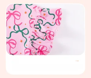 Détail de la robe en tricot rose avec poignets à volants et motifs imprimés colorés