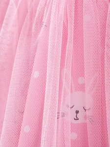Pink girls' dress featuring soft tulle layers with cute bunny and white polka dot prints
