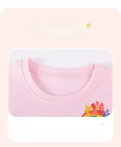 Detailed close-up of pink cotton t-shirt collar with bright floral and rainbow prints