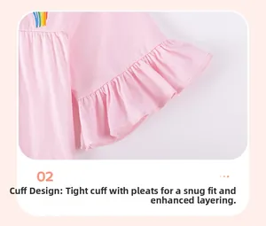 Detail of pink knitted girl's top with rainbow embroidery and ruffled sleeve edges