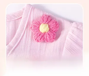 Detailed macro view of pink seersucker fabric with a handmade 3D knitted flower decoration