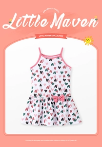 Detail of girls cotton sundress featuring colorful heart prints and a pink waist bow