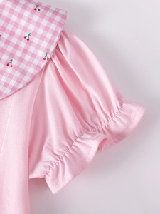Robe bébé rose en coton avec broderie cerise et détail de col à carreaux