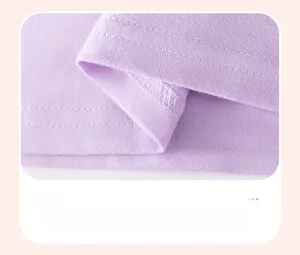 Close-up of smooth double-stitched hem on a breathable cotton purple girl's T-shirt
