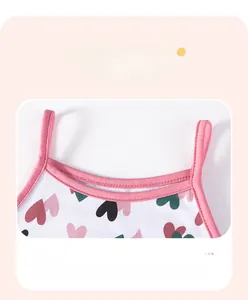 Detail of baby girl summer dress with heart pattern print and soft pink shoulder straps