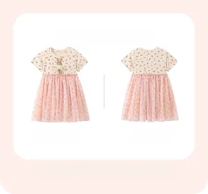 Close-up of girls' dress featuring cherry prints and a 3D bunny doll on pink mesh tulle