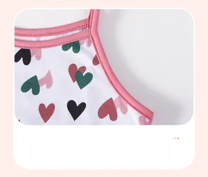 Close-up of pink neckline stitching and colorful heart pattern on cotton girl dress