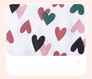 Macro detail of multicolored heart patterns on white cotton summer girl dress fabric