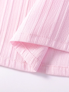 Pink seersucker summer girl dress featuring vertical stripe texture and quality stitching