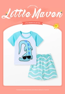 Detail of boys summer set with short sleeve raglan tee and wave print shorts