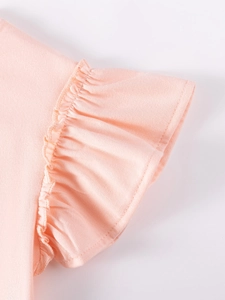 Pink girl's cotton dress featuring detailed ruffle trim and soft knit texture