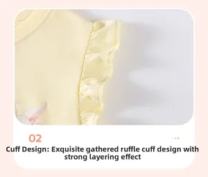 Detail of ruffled sleeve cuff and cartoon bunny print on yellow cotton girl's t-shirt