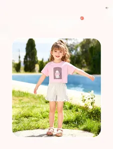 Detail of pink cotton T-shirt with bunny print and ruffled grey shorts for toddler girls
