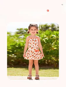 Close-up of watermelon print cotton summer dress with orange bow detail for girls