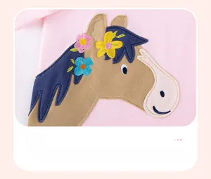 Close-up of pink cotton t-shirt featuring detailed horse embroidery and floral accents
