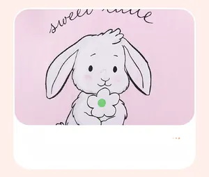 Detail of pink cotton fabric with a cute white rabbit print and sweet lettering