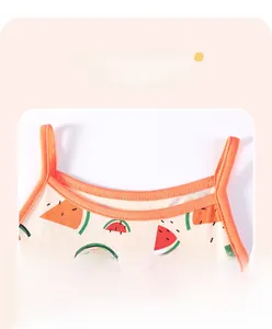 Close-up of cotton girl's sundress showing watermelon print and durable shoulder strap stitching