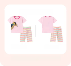 Detailed view of pink cartoon horse print top and colorful striped cotton pants set