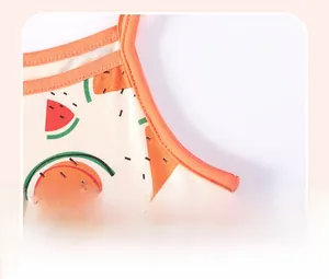 Detailed close-up showing neat stitching on a cotton baby dress with watermelon print