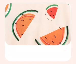 Detailed view of watermelon print on white cotton fabric for summer girl dress