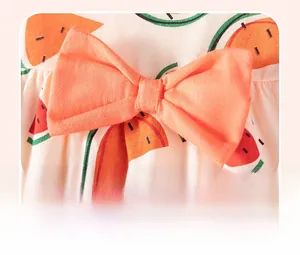 Detail shot of the 3D orange cotton bow and watermelon pattern on summer girl dress