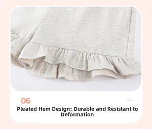 Detail view of the smocked ruffle hem on these light gray knit shorts for girls