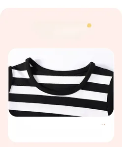 Close-up of crew neck design with binding detail on striped sleeveless girls dress