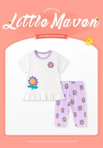 Detail of white ruffled cotton T-shirt and purple sunflower print pants for girls