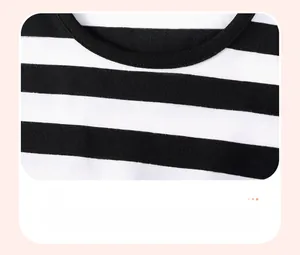 Close-up of black and white striped knit fabric and round neck design for girls dress
