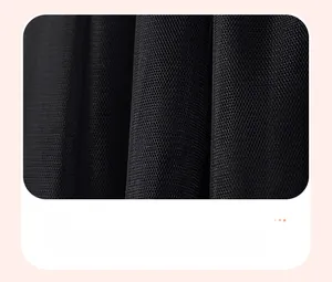 Detail of delicate black mesh fabric with pleated texture and fine netting for kids' dress
