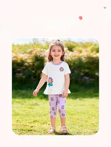 Detail of baby girl summer outfit featuring flower embroidery and purple ruffle hem