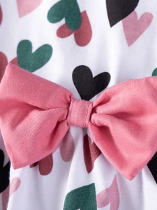 Girls summer strap dress with heart print and pink bow detail on soft white knit fabric