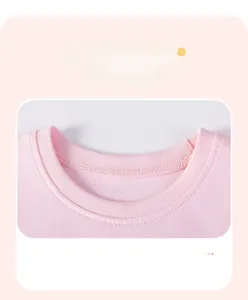 Detailed macro view of the soft pink cotton knit dress with a classic round neckline