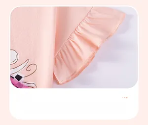 Detail of pink cotton girl's top featuring a delicate ruffle cuff and fine stitching