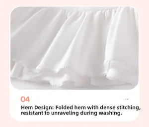 Detail of baby girl cotton top showing ruffled hemline with reinforced stitching