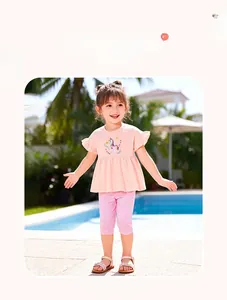 Girl's summer outfit featuring unicorn pink t-shirt with ruffles and striped leggings