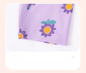 Detail of light purple baby trousers featuring daisy floral print and double-stitched cuffs