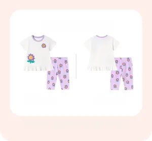 Detail view of girls floral summer set featuring white T-shirt and purple flower print pants