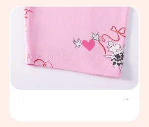 Close-up of pink cotton girl's shorts with cute cartoon heart and mouse pattern print