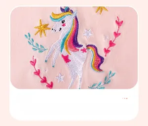 Detailed colorful unicorn embroidery on pink cotton fabric for girls' summer outfit