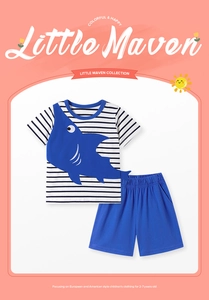 Detail of boys summer cotton set featuring shark embroidery on striped shirt and blue shorts
