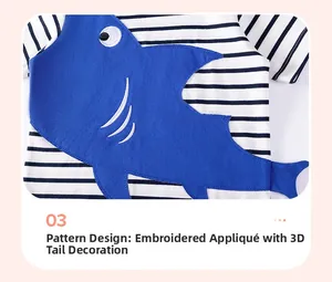 Detail of shark applique with 3D tail on black and white striped cotton kids t-shirt