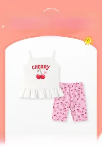 Detail of white cotton camisole with cherry print and matching floral shorts for girls