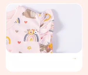 Detailed close-up of smocked ruffle cuffs on pink cotton kids T-shirt with cute prints