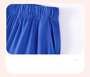 Detail of royal blue boys cotton shorts featuring an elastic waistband and side pockets