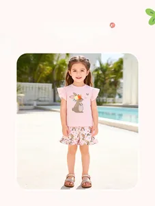 Close-up of pink girls' cotton summer outfit featuring cute rabbit and rainbow prints